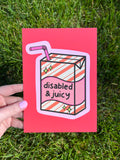 Art print with bright coral background with juice box in the center outlined in light pink. Juice box is cream with orange diagonal stripes and pink banner in the middle with yellow sparkles in either side. A pink straw is coming from the top. The black font on the juice box reads, "disabled and juicy". 