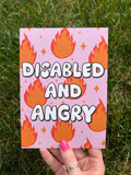 Art print with light pink background and flames in red and orange with sparkles around them with bubble letters outlined in black and filled in with white that read, "disabled and angry". The print is held over grass on a sunny day. 